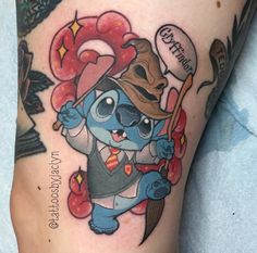 a cartoon character tattoo on the thigh