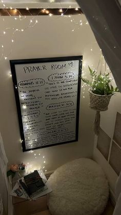 a room with lights and a chalk board on the wall above a bean bag chair