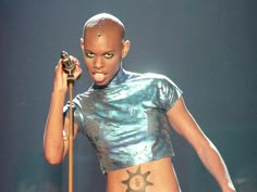 a woman with tattoos on her body holding a microphone