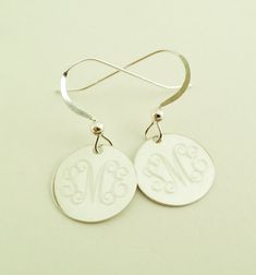 "Dangle Earrings in Sterling Silver Perfect present for Valentines Day or any occasion. Sterling silver dangle earrings will be monogrammed engraved permanently. Top quality 925 sterling silver. Comes gift boxed. Please state engraving information in notes to seller at checkout. Shown with Interlocking monogram, single initials also look very good on these. You can see font choices in extra photos. For Monograms please provide initials in first, last, middle order. Earrings- 1/2\" Sterling Silve Engraved Sterling Silver Earrings, Engraved Sterling Silver Round Earrings, Engraved Sterling Silver Dangle Jewelry, Personalized Drop Earrings For Anniversary, Classic Sterling Silver Initials Jewelry, Round Engraved Sterling Silver Earrings, Classic Sterling Silver Jewelry With Initials, Classic Sterling Silver Jewelry For Bridesmaids, Personalized Classic Silver Earrings