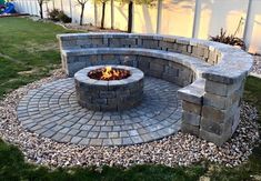 an outdoor fire pit in the middle of a yard