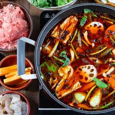 the cover of spicy sicilian hot pot is shown with ingredients in bowls and sauces