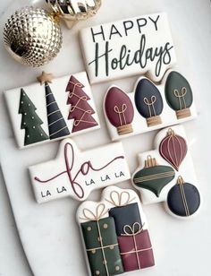 decorated cookies are displayed on a platter with holiday decorations in the shape of christmas trees