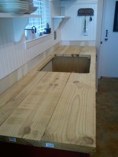 a kitchen counter made out of wood with a hole in the center that has been cut open