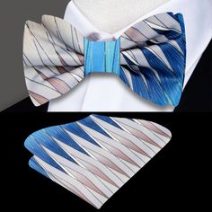 Elevate Your Ensemble with our Abstract Diamonds Silk Bow Tie Welcome to the world of refined fashion where every detail makes a statement. Introducing our latest creation: the Abstract Diamonds Silk Bow Tie. With its mesmerizing blend of shades of blue and brown in a jagged abstract diamonds pattern, this bow tie is more than just an accessory—it's a work of art that adds depth and sophistication to any outfit. Design and Options: Our Abstract Diamonds Silk Bow Tie is a testament to exquisite c Multicolor Summer Ties For Formal Occasions, Blue Suit And Tie Accessories For Summer Party, Elegant Multicolor Ties For Spring, Dapper Summer Party Suit And Tie Accessories, Dapper Summer Party Ties, Luxury Elegant Bow Tie For Semi-formal Occasions, Elegant Blue Summer Ties, Formal Pre-tied Ties With Decorative Bow, Elegant Fitted Multicolor Bow Tie