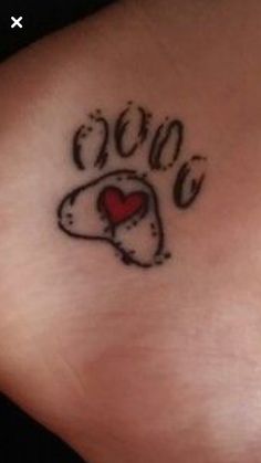 a dog paw with a heart tattoo on it's side ribcage and the word love written in cursive writing