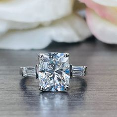 a diamond ring sitting on top of a wooden table