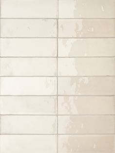 a white tiled wall with no one in it