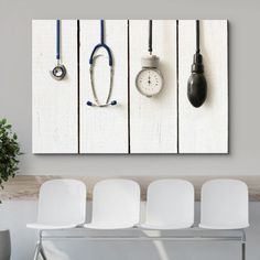 three white chairs are in front of a wall with two clocks and a stethoscope