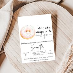 donuts, diapers and wipes are displayed on a wooden platter with napkins