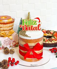 there is a cake that has been decorated with red ribbon on it and surrounded by other holiday foods