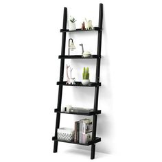 a black leaning shelf with books and vases on it