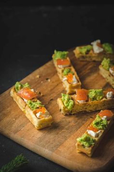 several pieces of food sitting on top of a wooden cutting board