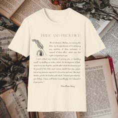 a t - shirt that reads pride and precuce on top of an open book