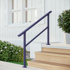 a set of stairs leading up to a white building with flowers in the foreground