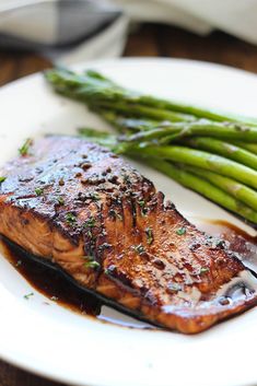 grilled salmon and asparagus on a white plate