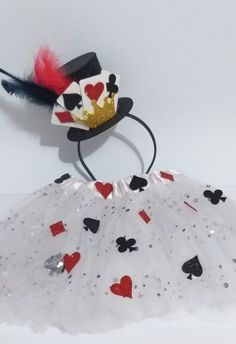 a white tutu skirt with red and black hearts on it, wearing a crown