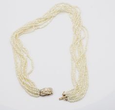 14 Karat Yellow Gold Multi Strand Fresh Water Pearl Necklace with Diamond & Gold Clasp Metal: 14k yellow gold Weight: 49.13 grams Diamonds: Approx. .15 CTW H-I SI Clasp: 19.5 - 11.5 MM Pearls: Baroque freshwater pearls approx. 3.5MM Length: 20 inches Formal Yellow Gold Multi-strand Jewelry, Formal Multi-strand Yellow Gold Jewelry, Pearl Necklace With Diamond, Fresh Water Pearl Necklace, Water Pearl Necklace, Necklace With Diamond, Pearl Clasp, Oval Diamond Engagement, Oval Diamond Engagement Ring