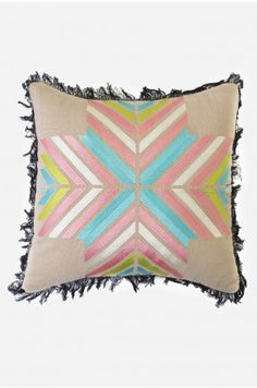 an embroidered pillow with fringes on the edges and multicolored geometric design,