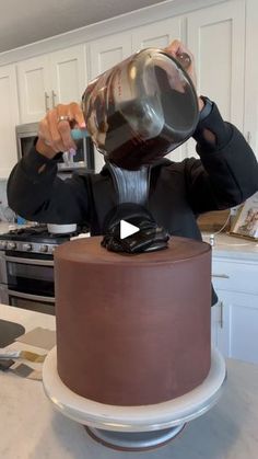 a man pours coffee into a glass on top of a cake