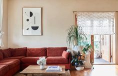 a living room filled with furniture and plants