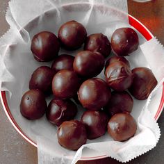 a white bowl filled with chocolate candies on top of a table