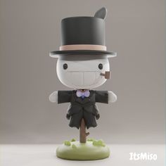 a small figurine with a top hat and coat on it's head