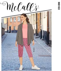 a woman in pink shirt and pants standing on cobblestone with text overlay