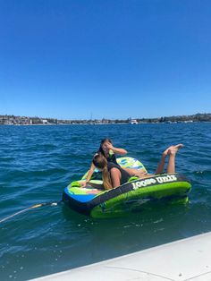 a woman riding on top of an inflatable boat