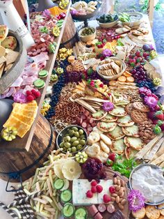 a table filled with lots of different types of food and snacks on it's sides