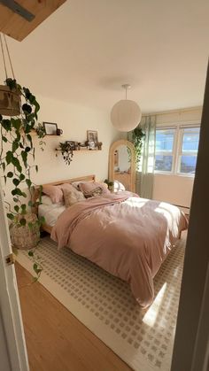 a bed sitting in a bedroom next to a window with plants growing on the wall