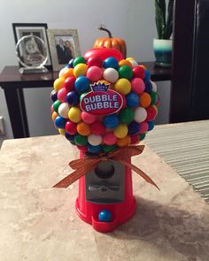 a gummy machine filled with lots of colorful candies on top of a table