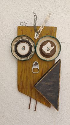 a wooden cutting board topped with plates and scissors next to a hair dryer on top of a wall