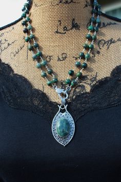 Embrace the enchanting beauty of the natural world with our Moss Agate & Double Strand Turquoise Beaded Necklace, a captivating piece that celebrates the harmony of earthy greens. Measuring a charming 20 inches in length, this necklace features a combination of Moss Agate and double strands of Turquoise beads. Moss Agate is known for its intricate patterns resembling a forest landscape, while Turquoise exudes a sense of tranquility and connection to nature. At the heart of this necklace, a penda Artisan Chrysocolla Jewelry With Polished Beads, Turquoise Malachite Beaded Jewelry, Bohemian Green Jasper Jewelry, Green Jasper Spiritual Jewelry, Bohemian Malachite Jewelry With Polished Beads, Green Turquoise Double Strand Bohemian Necklace, Green Double Strand Bohemian Turquoise Necklace, Green Bohemian Double Strand Turquoise Necklace, Bohemian Beaded Malachite Necklace With Natural Stones