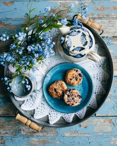 blueberry muffins on a plate with flowers