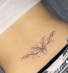 a woman's stomach with a tattoo on it