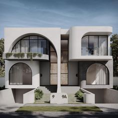 an architecturally designed house with two circular windows and balconies on the second floor