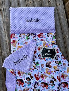 this is an image of a baby blanket with princesses on it and name tag