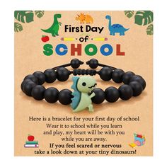 the first day of school bracelet is shown with an image of a dinosaur on it