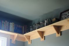 the shelves are made out of wood and have various items on them, including bookshelves