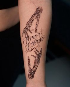 a tattoo on the arm that says armor and ferro with an image of two hands holding each other