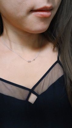 "A simple and minimal piece, this tiny bead necklace is sure to become an everyday staple for layering. 3 little satin finish round beads slide freely along delicate chain MATERIALS tarnish resistant rhodium silver filled or gold filled charm & chain DIMENSIONS 40.6cm (16\") plus 2\" extender chain, each bead measures 4mm (5/32\") diameter ◊ Matching sphere jewelry: https://www.etsy.com/shop/kindlingandco/search?search_query=ball ◊ More dainty charm necklaces: https://www.etsy.com/shop/kindl Sphere Jewelry, Tiny Bead Necklace, Bead Pendant, Charm Necklaces, Delicate Chain, Beaded Pendant, Necklace Silver, Minimalist Jewelry, Bead Necklace