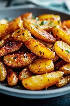 a plate full of fried potatoes with seasoning on top