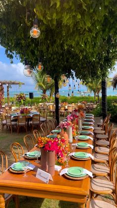 an outdoor dining area with tables and chairs set up for a formal function at the beach