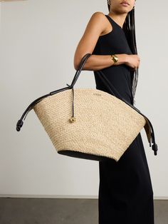 Loewe's 'Paseo' tote has space for all the necessities, whether you're planning a picnic or a trip to the beach. It's woven from raffia and has a gold-tone zip running through the black leather lid.  The supple top handles make it really easy to carry. Designer Travel Straw Bag With Handles, Designer Natural Straw Bag For Travel, Designer Straw Bag With Detachable Handle For Travel, Designer Travel Straw Bag With Detachable Handle, Elegant Straw Bag With Leather Trim For Travel, Loewe Puzzle Bag, Loewe Bag, Flat Dress Shoes, Gucci Eyewear