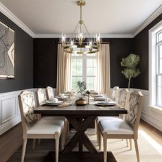 the dining room table is set for four with white chairs and place settings on it