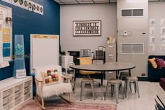 a room with a table, chair and refrigerator in it's centerpieces