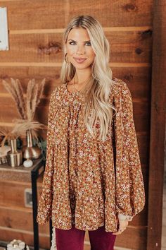 Make a not so subtle entrance in this eye-catching mustard colored top featuring lightweight flowy material patterned with a darling cream and neutral hued floral print, a rounded neckline, 3/4-length bubble sleeves, a keyhole accented upper back with a button closure, and a relaxed silhouette that falls into a flirty peplum hemline! Brown Floral Print Long Sleeve Blouse, Flowy Yellow Blouse For Fall, Brown Floral Print Top For Brunch, Mustard Long Sleeve Blouse For Fall, Flowy Brown Blouse For Fall, Brown 3/4 Sleeve Blouse For Fall, Flowy Brown Blouse For Spring, Brown Flowy Long Sleeve Tops, Flowy Brown Long Sleeve Tops