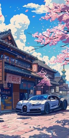 a car parked in front of a building with cherry blossom trees on the side of it