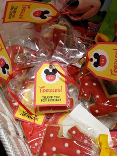 mickey mouse cookies in plastic wrappers with tags on them